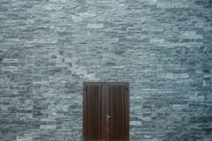 brown-wooden-door-on-a-flat-bricked-wall-2879602