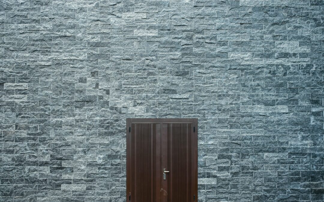 brown-wooden-door-on-a-flat-bricked-wall-2879602